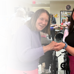 Senior woman dancing with a staff member at Chantilly Heights